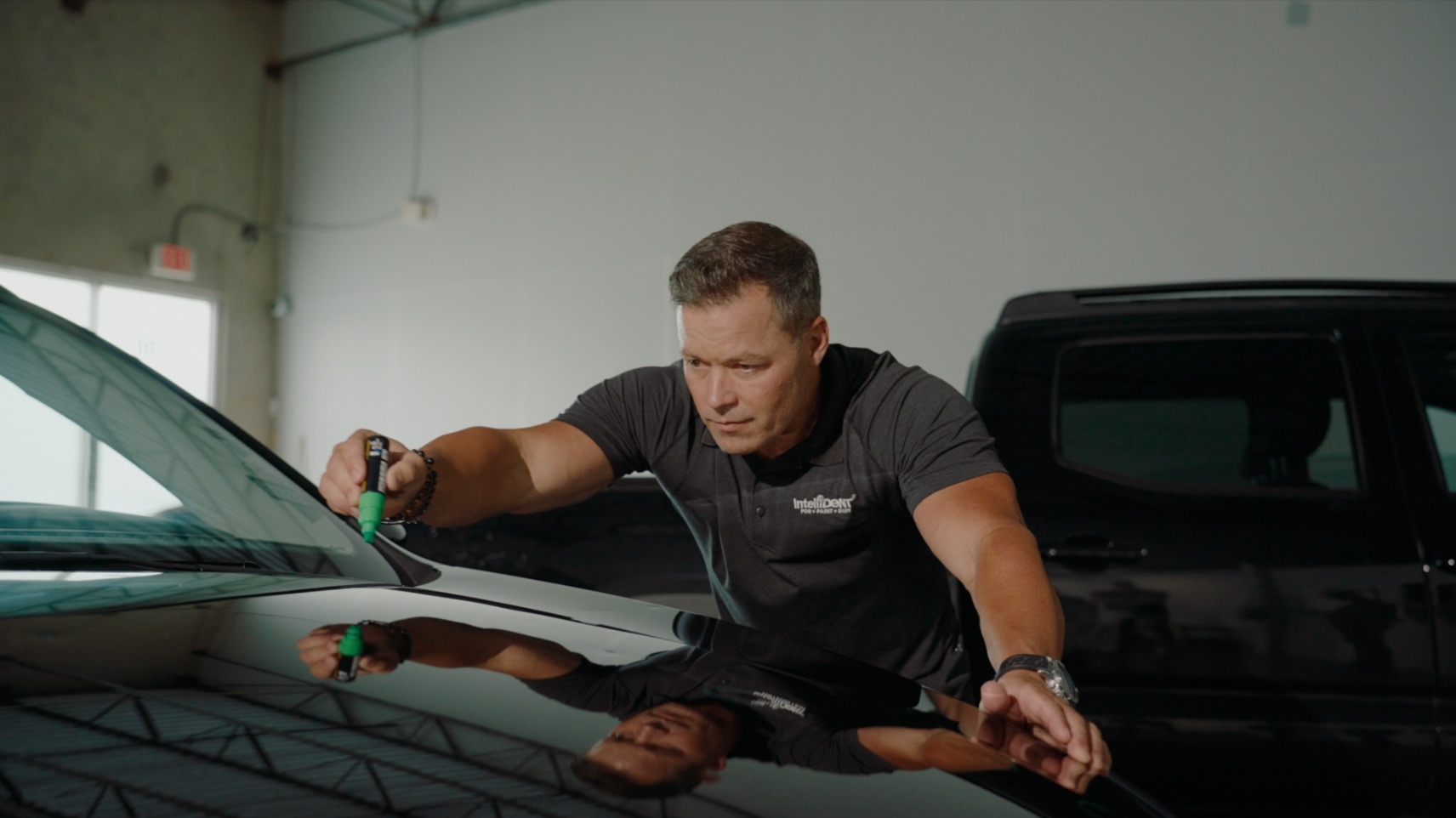 Marking dents on hood of car