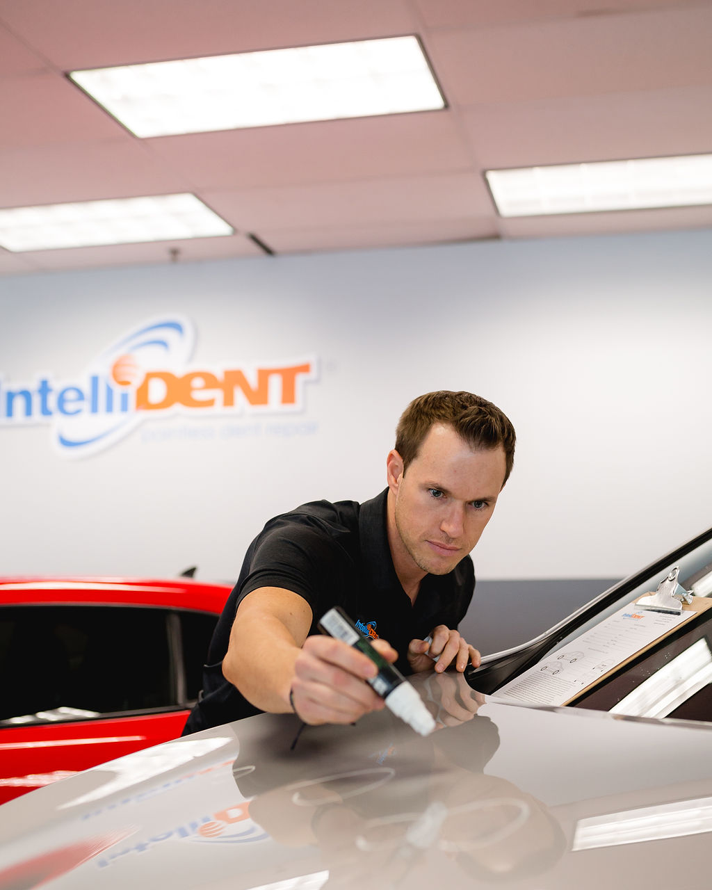 Marking hail dents on hood of car